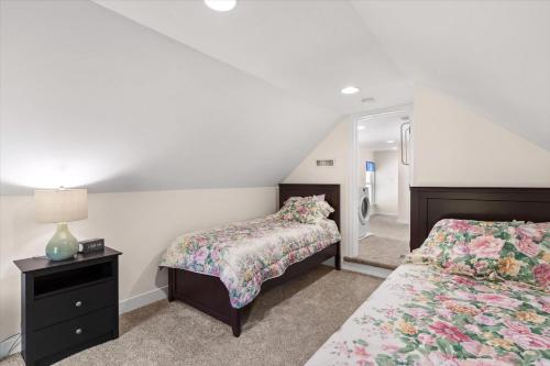 a bedroom with two beds and a mirror at Precious Time in Chincoteague