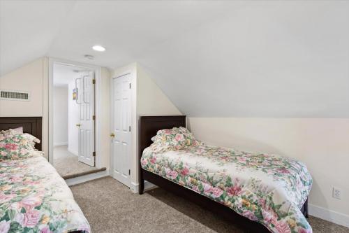 a bedroom with two beds and a staircase at Precious Time in Chincoteague