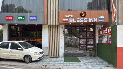 a white car parked in front of a building at Hotel bless inn in Bankipur