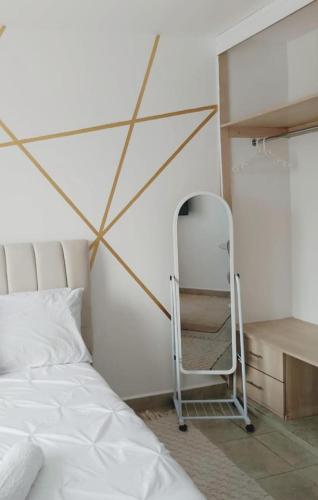 a bedroom with a bed and a ladder next to a shelf at Neema Homes Syokimau in Nairobi