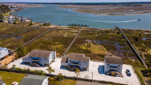 an aerial view of a house next to the water at Pony Swim Crossing in Black Point Landing
