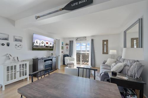 a living room with a couch and a tv at Pony Swim Crossing in Black Point Landing