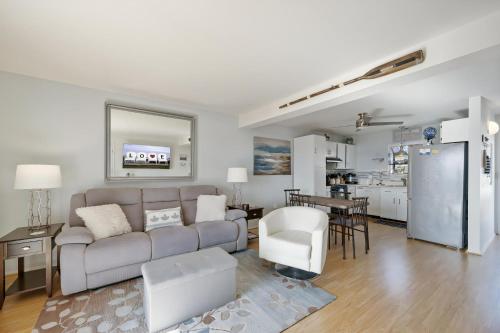 a living room with a couch and a kitchen at Pony Swim Crossing in Black Point Landing
