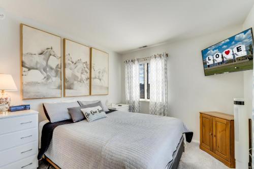 a white bedroom with a bed and a window at Pony Swim Crossing in Black Point Landing