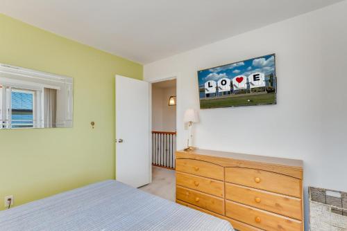 a bedroom with a bed and a dresser at Pony Swim Crossing in Black Point Landing