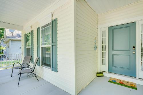 a porch with a chair and a blue door at The Shore Shanty in Greenbackville