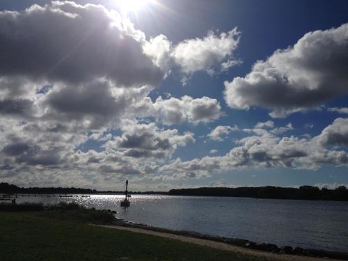 a large body of water with a lighthouse in the middle at Charmerende byhus - tæt på alt! in Svendborg