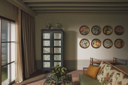 a living room with plates on the wall at Villa San Michele, A Belmond Hotel, Florence in Fiesole