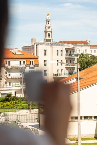 a view of a building with a clock tower at Hotel Santo Amaro - SA Hotels in Fátima