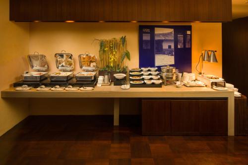 a table with plates and other items on it at les suites taipei ching cheng in Taipei