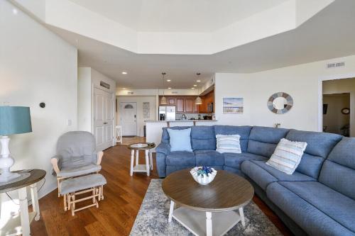 a living room with a blue couch and a table at Sunset Bay Villa 313 - By The Bay in Chincoteague
