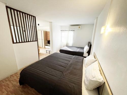 a hotel room with a bed and a bedroom at 7HOUSE เซเว่นเฮ้าส์ - Racha caftel in Chiang Mai