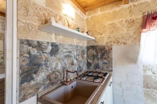 a kitchen with a sink and a stove at Monolocale Emy - Salento Reservation in Il Monte