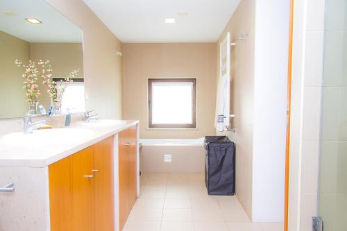 a bathroom with a sink and a bath tub at Liiiving in Caminha | Oak Tree Chill House in Caminha