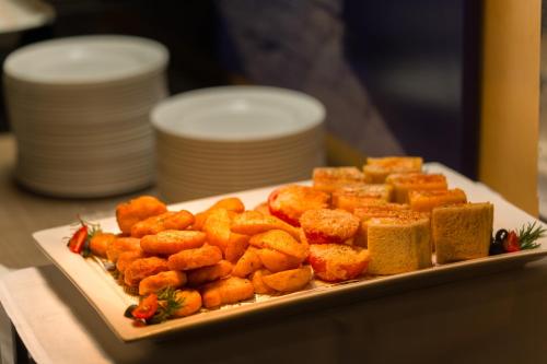 a plate of food on a table with some food at les suites taipei ching cheng in Taipei