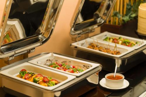 three trays of food sitting on a table at les suites taipei ching cheng in Taipei