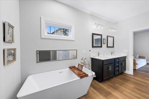 a white bathroom with a tub and a sink at 116 Pine Forest Drive in Ocean Pines