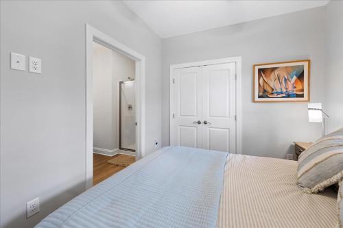 a white bedroom with a bed and a mirror at 116 Pine Forest Drive in Ocean Pines