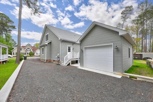 a gray house with a garage on a driveway at 116 Pine Forest Drive in Ocean Pines
