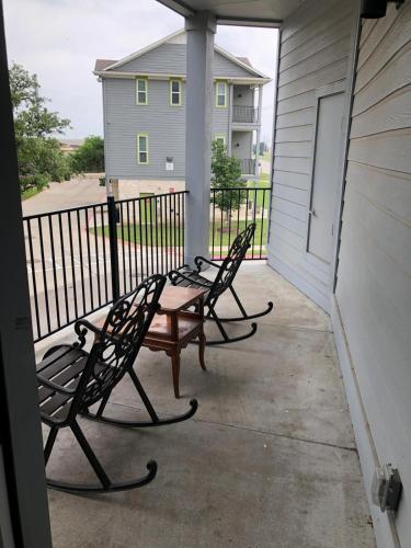 three chairs and a table on a porch at Stylish Apartment in Austin in Leander