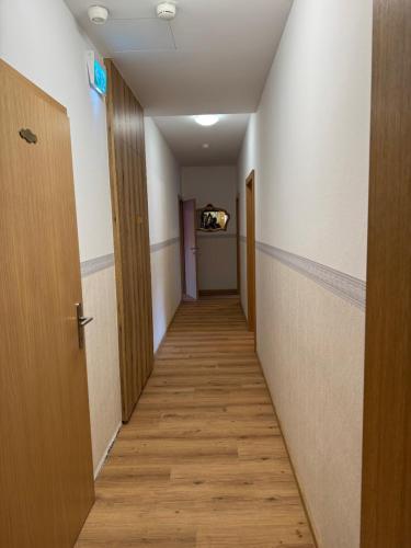 a corridor of an empty room with a hallway at Hotel Garni Wolfgang in Saalbach Hinterglemm