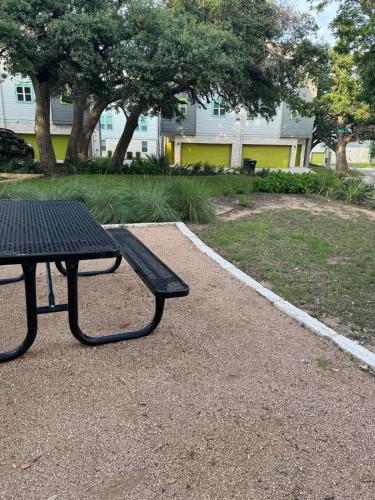 a black picnic table sitting in a park at Stylish Apartment in Austin in Leander