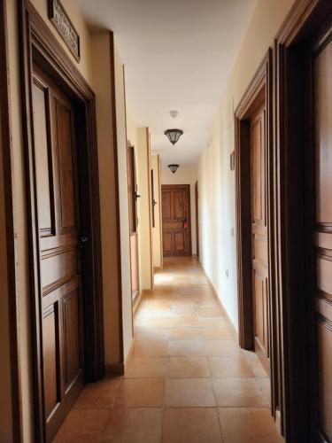 a hallway with doors and a tiled floor at Jayca in Trujillo