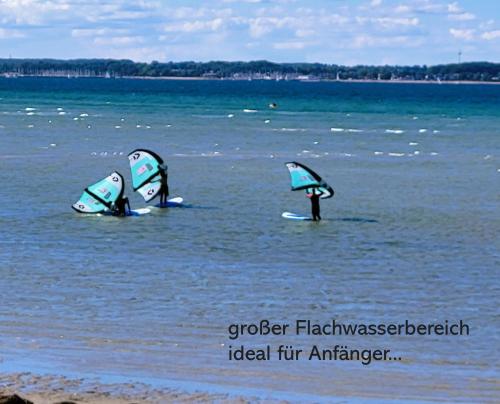 three people in the water with windsurfing at Neustein 07 in Stein