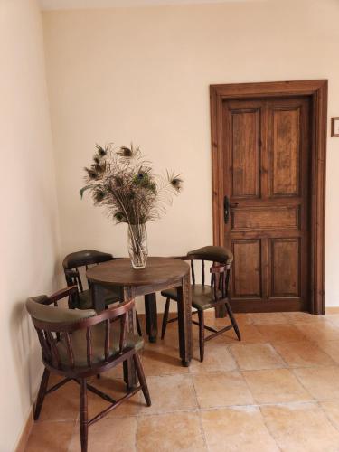 a table and chairs with a vase of flowers on it at Jayca in Trujillo