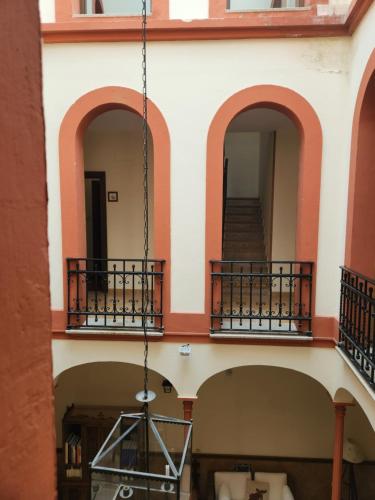 a building with three balconies and a staircase at Jayca in Trujillo