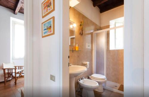 a bathroom with a toilet and a sink at Villa Lina in Lezzeno