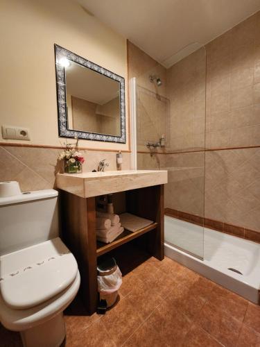 a bathroom with a toilet and a sink and a shower at Jayca in Trujillo