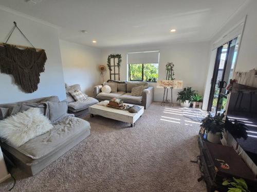a living room with two couches and a couch at Bethlehem Home, plus Self Contained Apartment in Tauranga