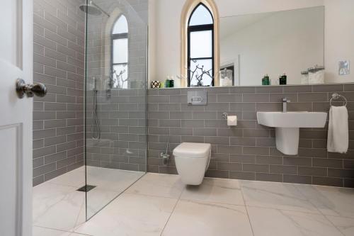 a bathroom with a toilet and a sink and a shower at South Lodge, St Osyth Priory in Saint Osyth
