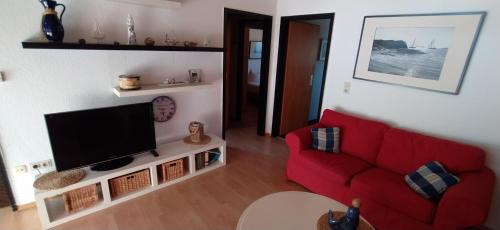 TV a/nebo společenská místnost v ubytování Ferienhaus Am Yachthafen 182