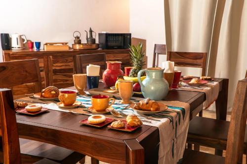 a table with plates of food on it at Villa Amoroso - Ospitalità Mediterranea in Agrigento