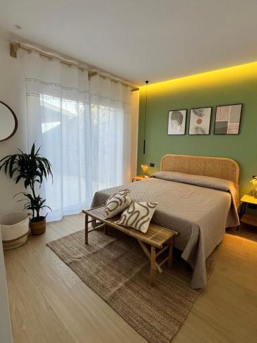 a bedroom with a large bed and a green wall at Villa Anthea - Relax vista mare tra Palermo e Cefalù in Trabia