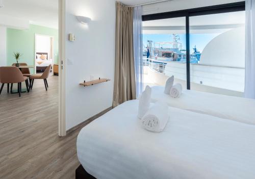 a bedroom with a large bed with a view of the ocean at Résidence Cap Winston in Cap d'Ail