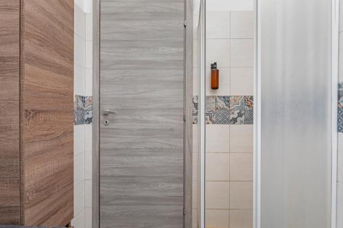 a door in a bathroom with a shower at Holiday Home Castello in Aci Castello