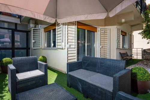two blue wicker chairs sitting on a patio at Holiday Home Castello in Aci Castello
