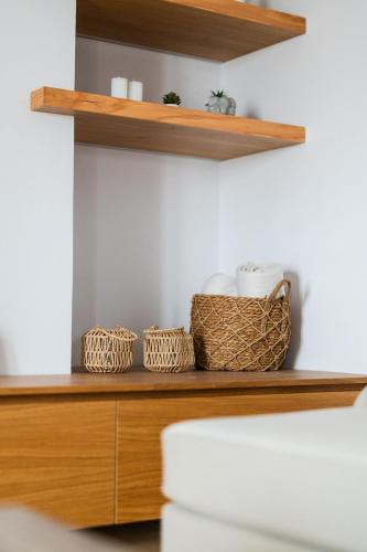 a wooden shelf with baskets on top of it at MD Horizon with private Jacuzzi near the beach in Anissaras