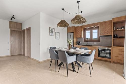 a kitchen with a dining room table and chairs at MD Horizon with private Jacuzzi near the beach in Anissaras