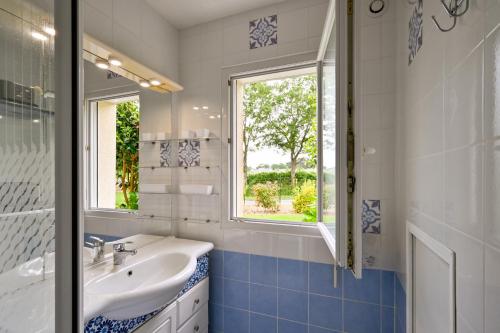 a bathroom with a sink and a window at La Maison d'Herbignac - Grand Jardin in Herbignac