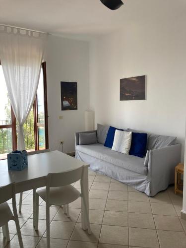 a living room with a couch and a table at Il Casalino in Maratea