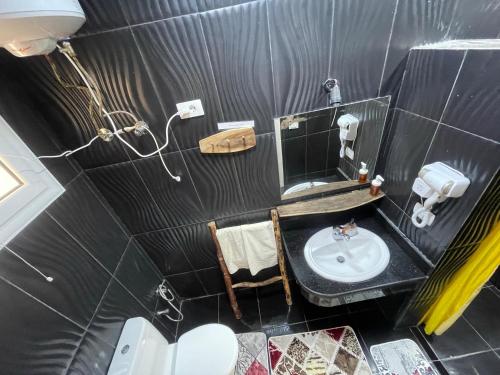 a small bathroom with a sink and a mirror at Skyrock Dahab in Dahab