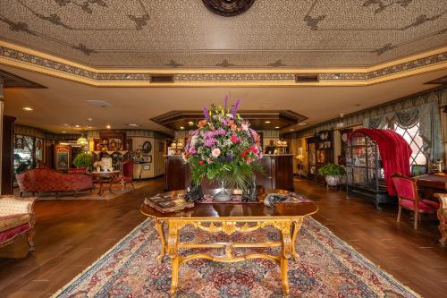 a living room with a table with flowers on it at Boardwalk Plaza Hotel in Rehoboth Beach