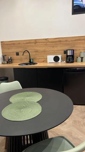 a table with plates on it in a kitchen at Chez sousouzen in Dunkerque