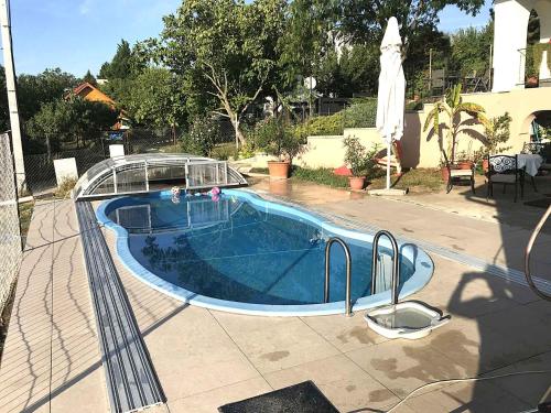 a small swimming pool with a glass fence around it at Holiday home in Balatonalmadi 38980 in Balatonalmádi