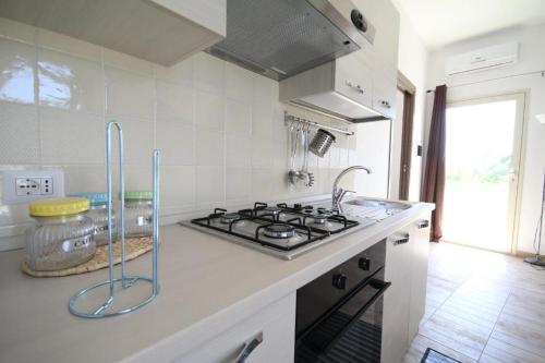 a kitchen with a stove and a counter top at Villa Marika in Fontane Bianche