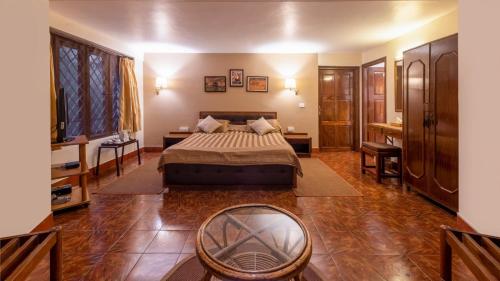 a bedroom with a bed and a mirror in it at Tranquil Resort - Blusalzz Collection, Wayanad - Kerala in Ambalavayal